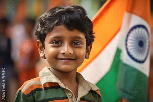 Young smiling Indian boy holding Indian flag, symbolizing patriotism and national pride. Celebrating Indian Independence Day. Love for the country. photo