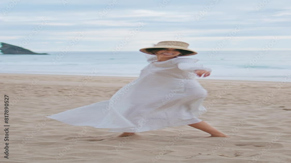 Joyful model dancing beach on cloudy day vertical. Happy woman enjoying summer Joyful model dancing beach on cloudy day vertical. Happy woman enjoying summer