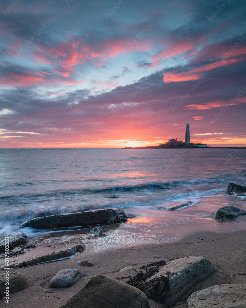 Sunrise over St Mary's Lighthouse and island at Whitley Bay on the north east coast of England, UK. Sunrise over St Mary's Lighthouse and island at Whitley Bay on the north east coast of England, UK.