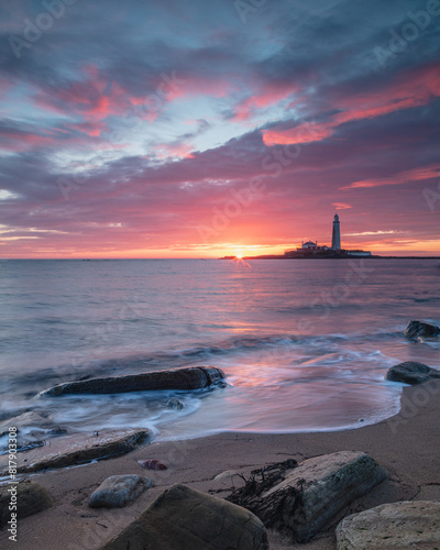 Sunrise over St Mary's Lighthouse and island at Whitley Bay on the north east coast of England, UK.