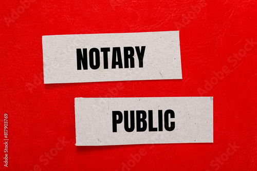 Notary public words written on paper pieces with red background. Conceptual notary public symbol. Copy space. © Emre Akkoyun