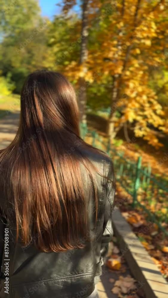 A charming, sunny girl brings joy to the autumn streets as she walks on a sunny day. A charming, sunny girl brings joy to the autumn streets as she walks on a sunny day.