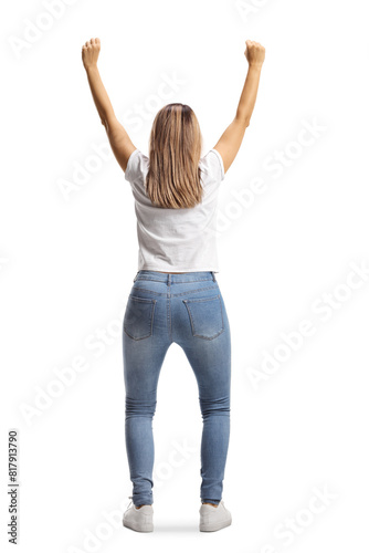 Fotografija Rear view shot of a happy young woman cheering with arms up