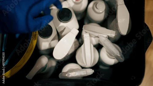 close-up from above there different white cleaning products in the bag and they take a bottle