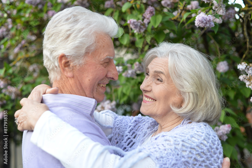 Portrait of beautiful senior couple by lilacs in the park Portrait of beautiful senior couple by lilacs in the park