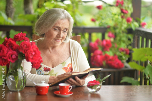 Close up portrait of beautiful senior woman with book