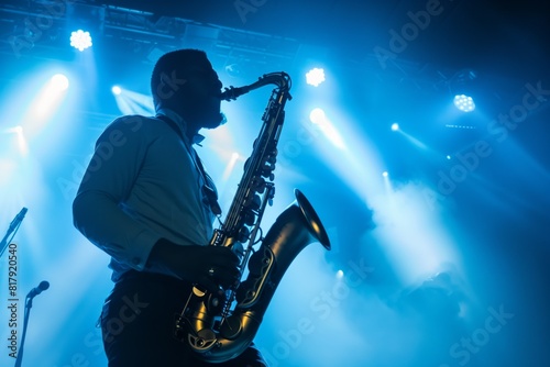 Silhouette of a saxophonist performing on stage with vibrant lighting and smoky atmosphere.