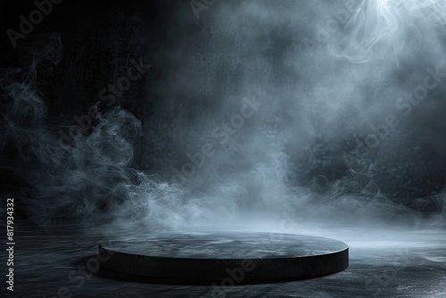 A smokey, dark room with a large, round, empty stage. The stage is surrounded by a lot of smoke, giving it a mysterious and eerie atmosphere