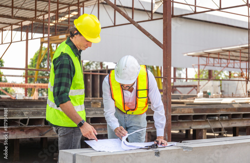 Engineer and foreman worker team with blueprints checking project at the precast concrete factory site, Engineer and builders in hardhats discussing on construction site