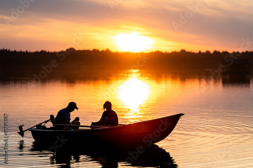 Two People in Boat on Lake at Sunset