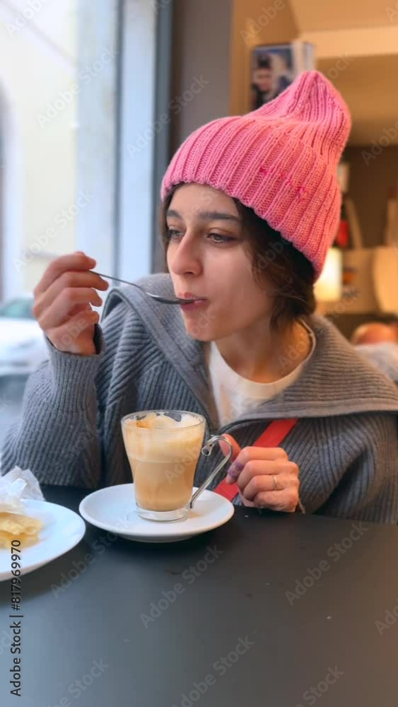 A stylish lady relishes breakfast and engaging conversation with companions at a coffee shop. A stylish lady relishes breakfast and engaging conversation with companions at a coffee shop.