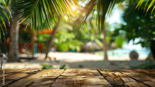 Fototapeta Naklejka Na Ścianę i Meble -  Empty wooden table top for product display, presentation stage. Tropical summer, palm trees, beach bar, white sand and blue ocean in the background. 