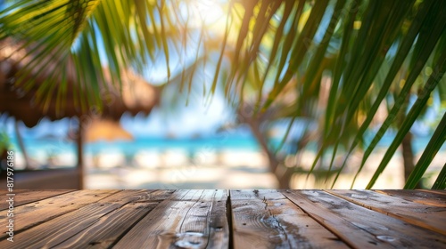 Fototapeta Naklejka Na Ścianę i Meble -  Empty wooden table top for product display, presentation stage. Tropical summer, palm trees, beach bar, white sand and blue ocean in the background. 