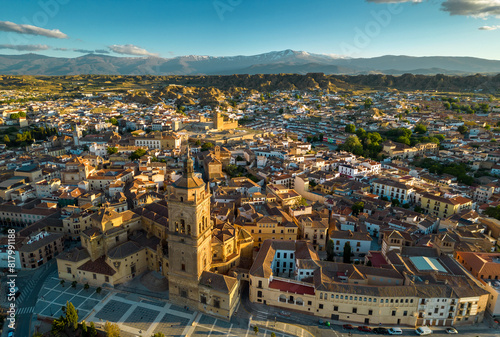 Aerial drone view of Guadix city. Historic and medieval city of Guadix lies at an altitude of 913 metres. In background is Sierra Nevada Mountain, with snow on peaks. Sunset. Sunset point. 