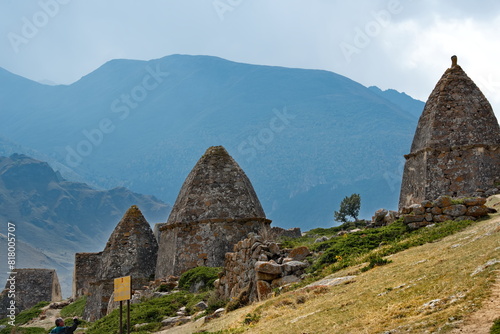 Russia. North Caucasus, Kabardino-Balkaria. A picturesque panorama of stone crypts in the City of the Dead of the XI century near the village of Eltyub in the Chegem gorge. photo