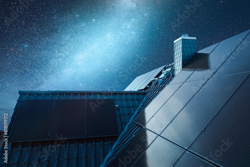 Roof of a House with Solar Panels Under a Starry Night Sky