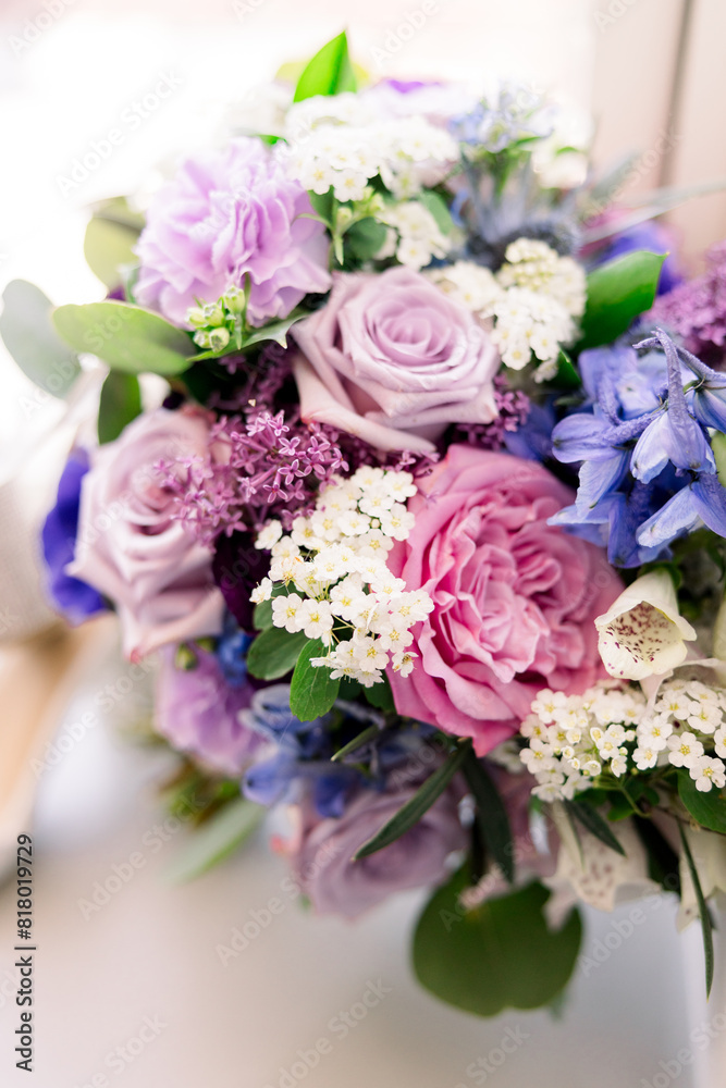 A close-up of a beautiful purple and pink bridal bouquet. 
