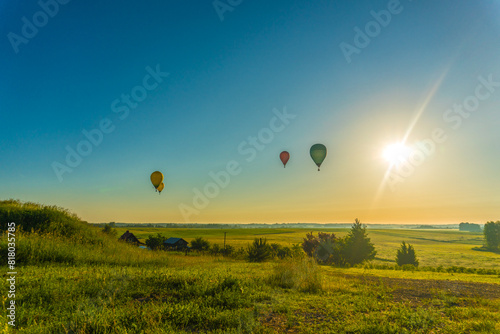 hot air balloons over rural landscape