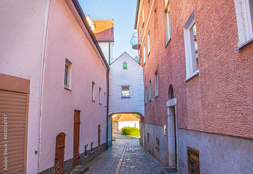 narrow European street, pink stone walls, an arch narrow European street, pink stone walls, an arch