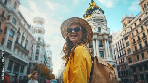 Young travel woman sightseeing urban outdoors.Traveling to Europe. Walking tour in Madrid.Backpack tourist experience.City girl.Cheerful tourist.Visiting Plaza Major square  