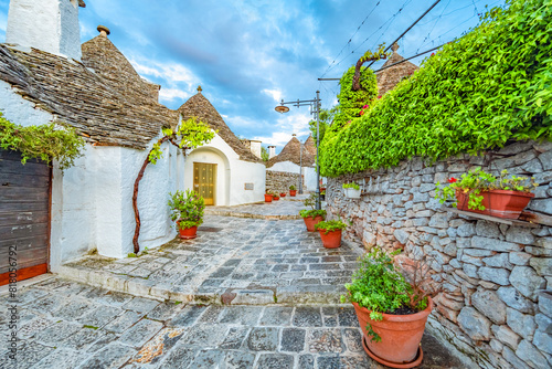 Trulli of Alberobello, Puglia, Italy. town of Alberobello with trulli houses among green plants and flowers