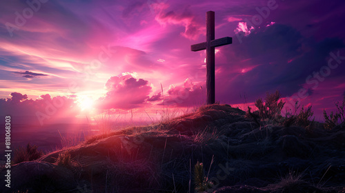 a cross on a hill with a sunset in the background