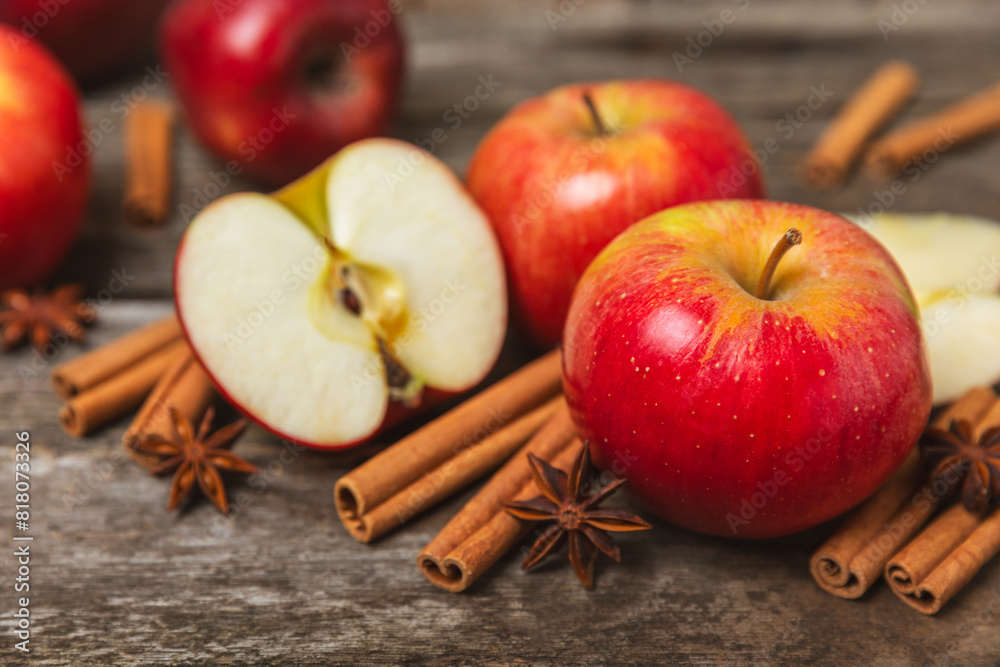 Apples with cinnamon on a textured wooden background. Fragrant red spiced apples with cinnamon sticks and star anise. Apple slices with spicy spices. Place for text. Copy space. Harvesting. Fruits. Apples with cinnamon on a textured wooden background. Fragrant red spiced apples with cinnamon sticks and star anise. Apple slices with spicy spices. Place for text. Copy space. Harvesting. Fruits.