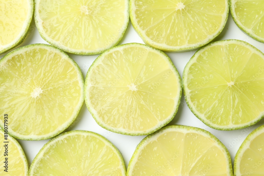 Fresh juicy lime slices on white background, flat lay Fresh juicy lime slices on white background, flat lay