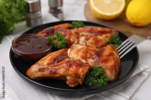 Fresh marinade and chicken wings on table, closeup