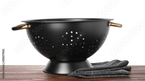 Black empty colander and napkin on wooden table against white background