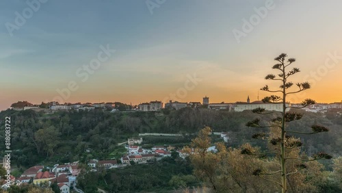 Panorama showing sunset over the Castle of Almourol on hill in Santarem aerial timelapse. A medieval castle atop the islet of Almourol in the middle of the Tagus River and houses. Portugal photo