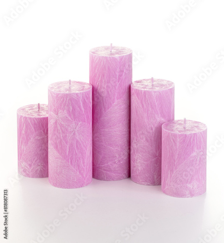 Natural pirple palm wax pillar candles of varying heights; featuring unique ice pattern texture grouped on white background. Handmade accessories for refreshing interior decor