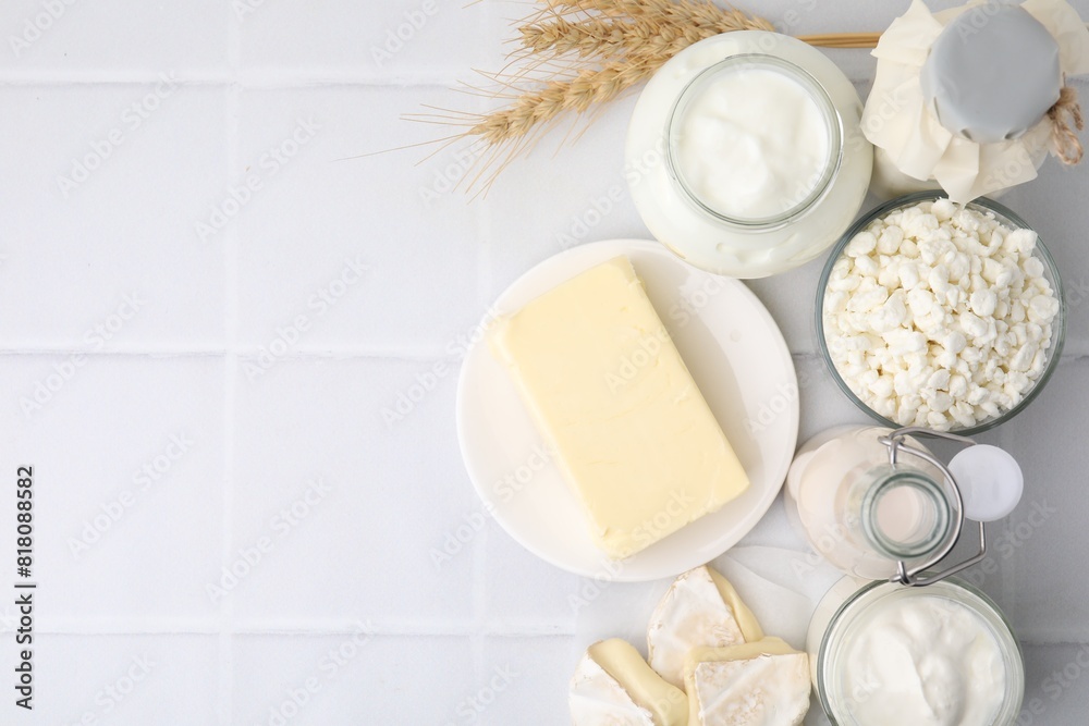 Different dairy products and spikes on white tiled table, flat lay. Space for text Different dairy products and spikes on white tiled table, flat lay. Space for text