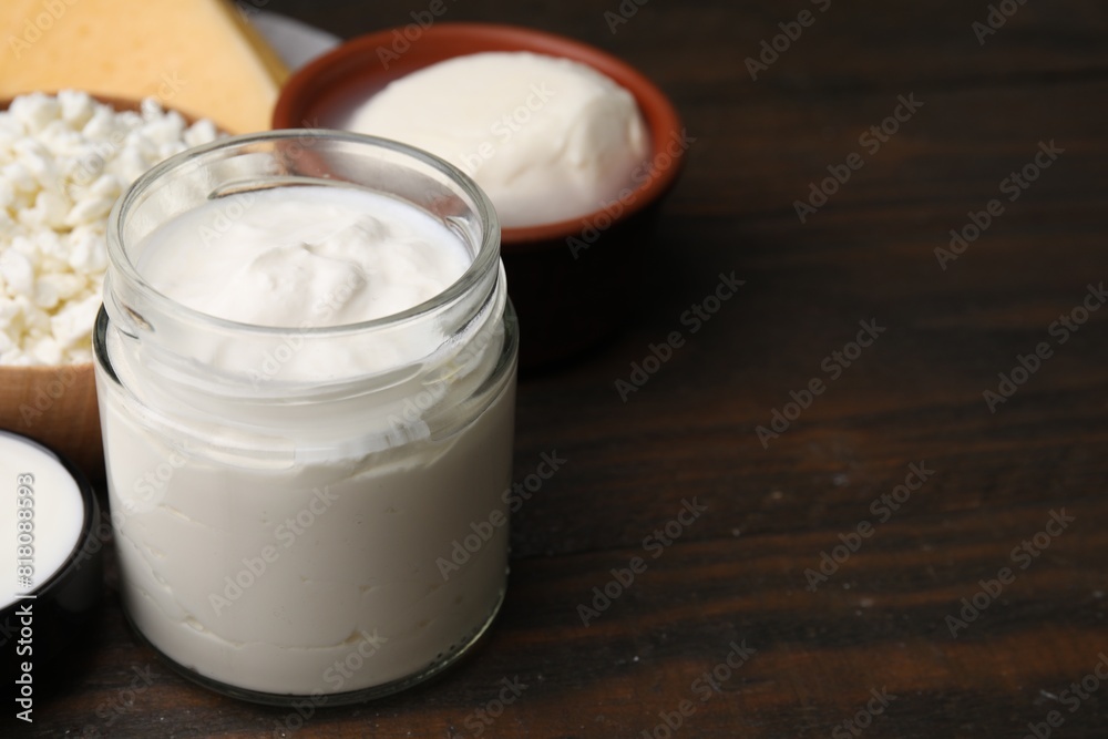 Different fresh dairy products on wooden table, space for text Different fresh dairy products on wooden table, space for text