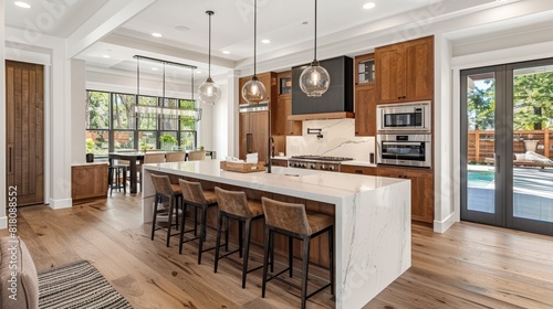 Contemporary kitchen with a large island, minimalist design, and stylish pendant lights