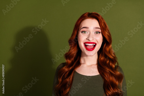 Photo of shiny attractive lady dressed shirt open mouth empty space isolated green color background © deagreez