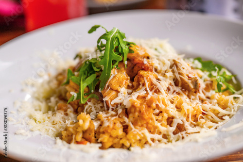 Risotto with chicken meat, grated cheese and rucola leaf.