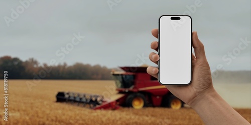 Hand holding a phone with a against a farm bg, for agriculture-related mockups