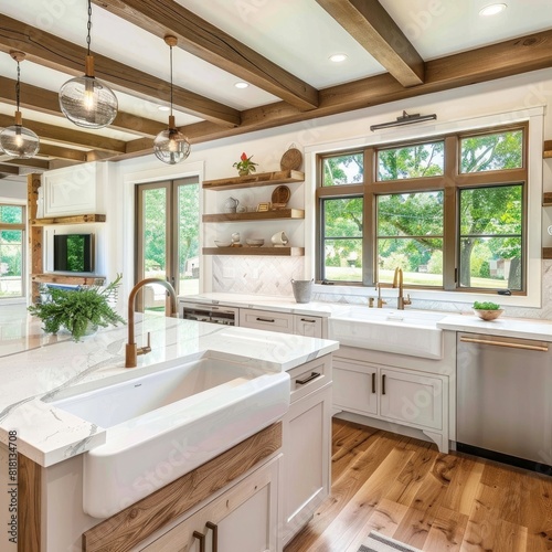 Traditional kitchen in new luxury home with farmhouse sink  hardwood floors  wood beams  large island and quartz counters. Features large windows inviting abundant natural light  and floating shelves