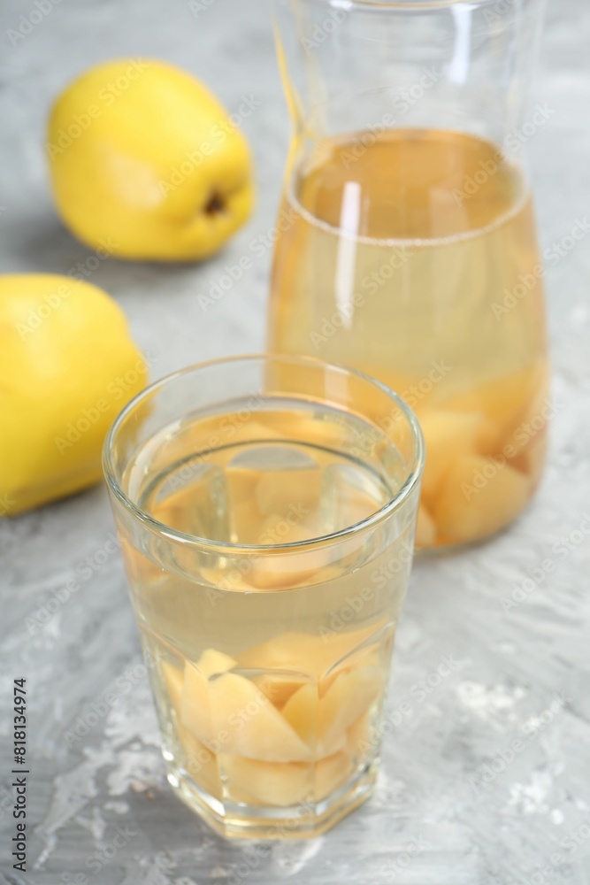 Delicious quince drink and fresh fruits on grey table, closeup Delicious quince drink and fresh fruits on grey table, closeup