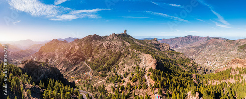 Roque Nublo and Pico de Teide in the background on Gran Canaria Island, Spain. Panoramic view of Roque Nublo sacred mountain, Roque Nublo Rural Park, Gran Canary, Canary Islands, Spain.