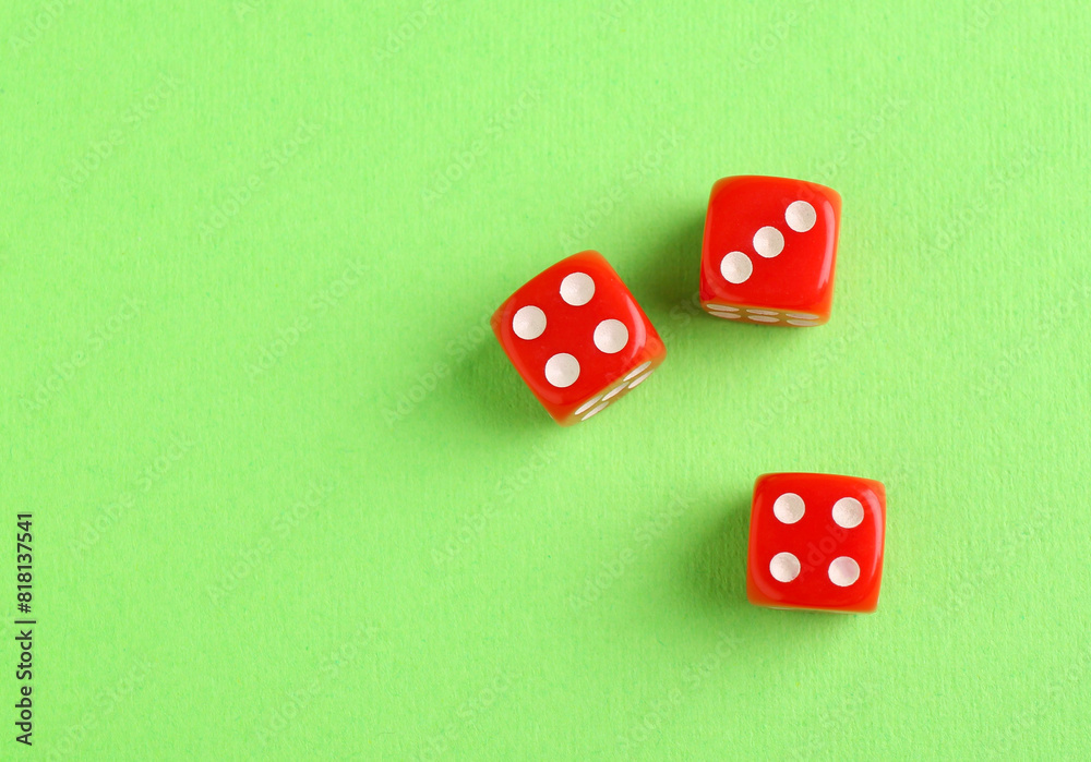 Three red game dices on green background, flat lay Three red game dices on green background, flat lay