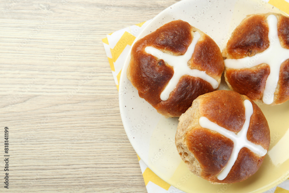 Tasty hot cross buns on wooden table, top view. Space for text Tasty hot cross buns on wooden table, top view. Space for text