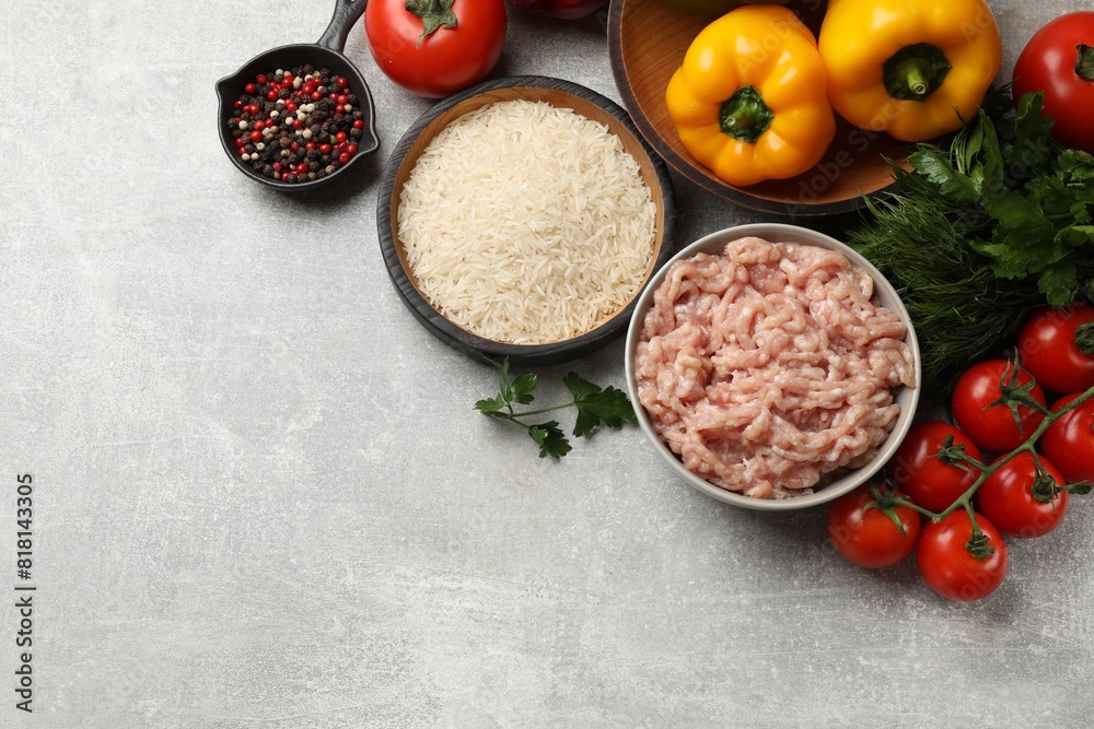 Making stuffed peppers. Ground meat and other ingredients on grey table, flat lay. Space for text