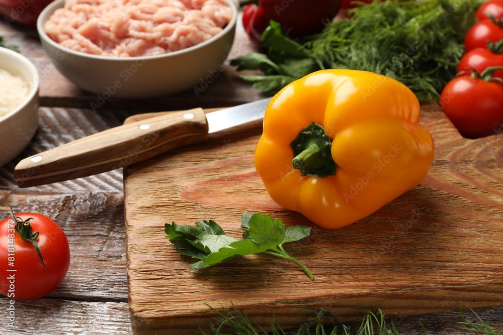 Making stuffed peppers. Ground meat and other ingredients on wooden table Making stuffed peppers. Ground meat and other ingredients on wooden table