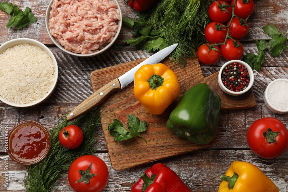 Making stuffed peppers. Ground meat and other ingredients on wooden table, flat lay Making stuffed peppers. Ground meat and other ingredients on wooden table, flat lay