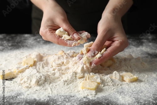 Woman making shortcrust pastry at table, closeup photo