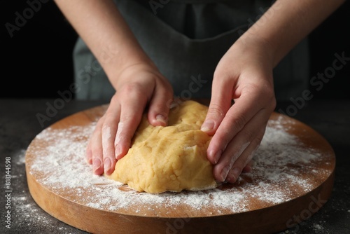 Making shortcrust pastry. Woman kneading dough at table, closeup photo