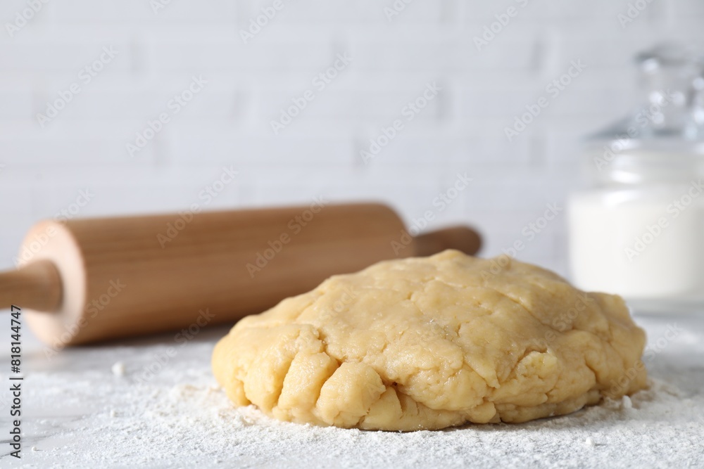 Making shortcrust pastry. Raw dough, flour and rolling pin on table Making shortcrust pastry. Raw dough, flour and rolling pin on table