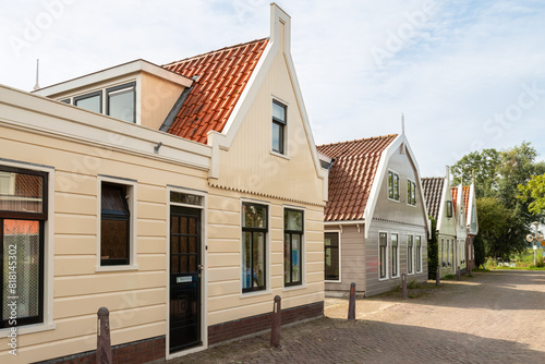 Traditional wooden picturesque houses in the small narrow Dutch village of Zunderdorp.